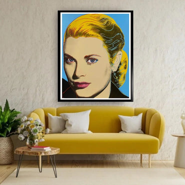Framed portrait above a yellow sofa in a living room setting