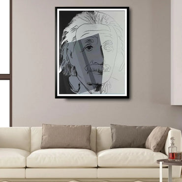 Framed abstract art of a face on a wall above a beige sofa.