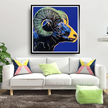 Framed artwork of a ram on a wall above a white sofa with colorful cushions.