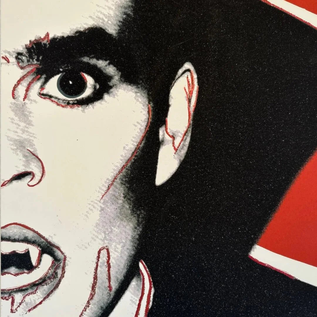 Close-up of a stylized face with red accents on a black background