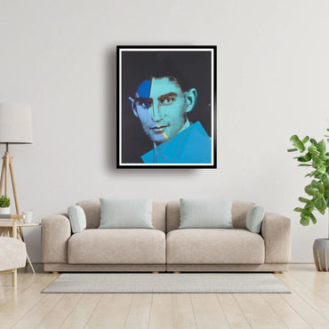 Framed artwork of a stylized portrait above a beige sofa in a living room.
