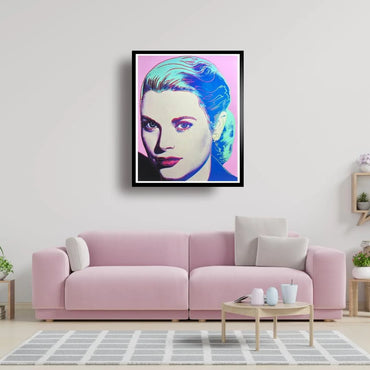 Framed artwork of a stylized portrait on a wall above a pink sofa in a living room.