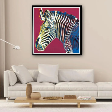 Framed artwork of a zebra on a wall above a white sofa in a living room.
