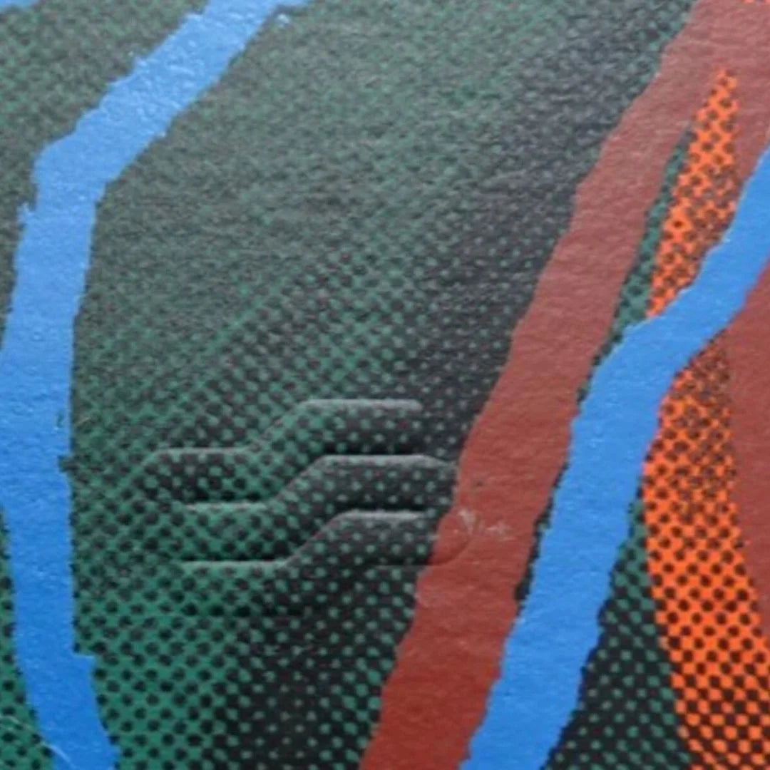 Close-up of textured fabric with blue, green, and orange patterns