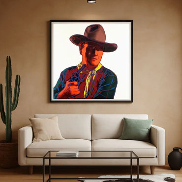 Framed artwork of a colorful cowboy portrait above a beige sofa in a living room.