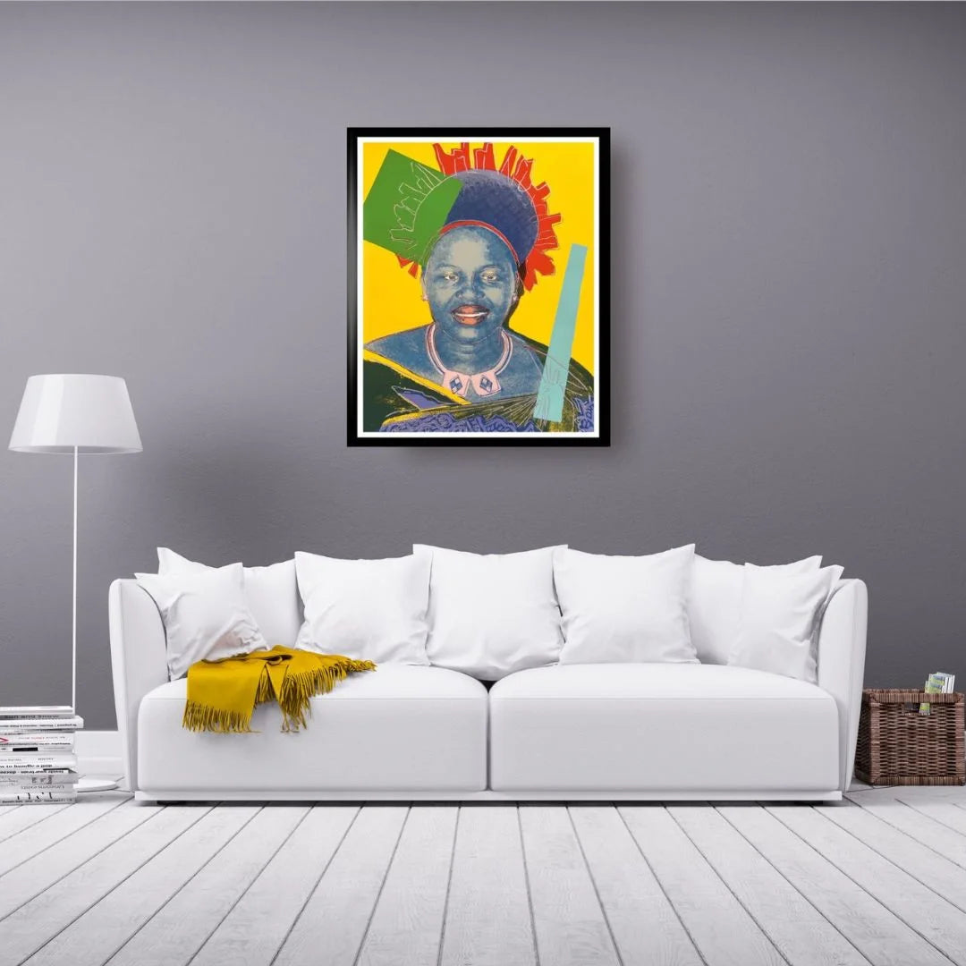 Colorful painting of a woman on a gray wall above a white sofa with a yellow blanket.