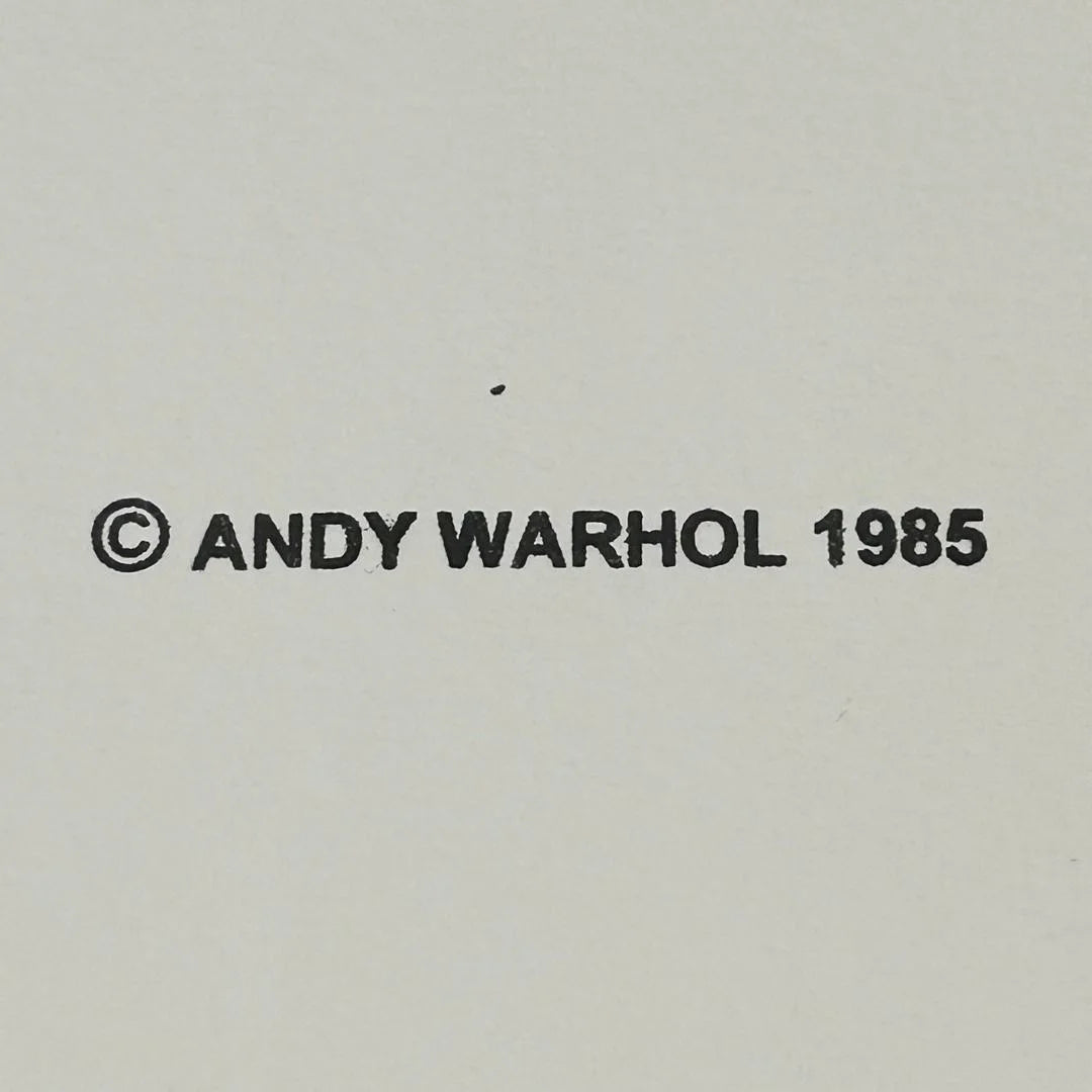 Andy Warhol copyright with the year 1985 on a plain background