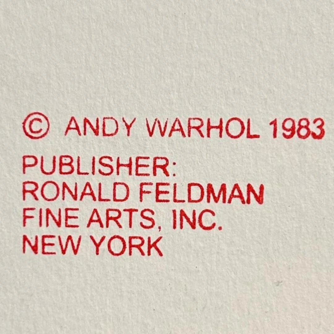 Red text on a beige background with copyright information for Andy Warhol and Ronald Feldman Fine Arts, Inc.