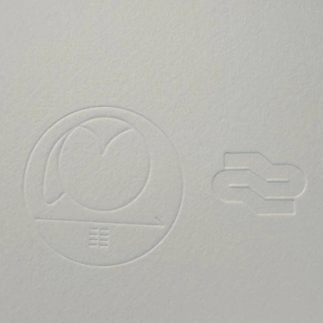 Gray textured surface with embossed circular design and number '2'
