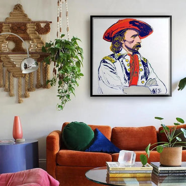Living room with a colorful framed portrait on the wall, orange sofa, and decorative items.