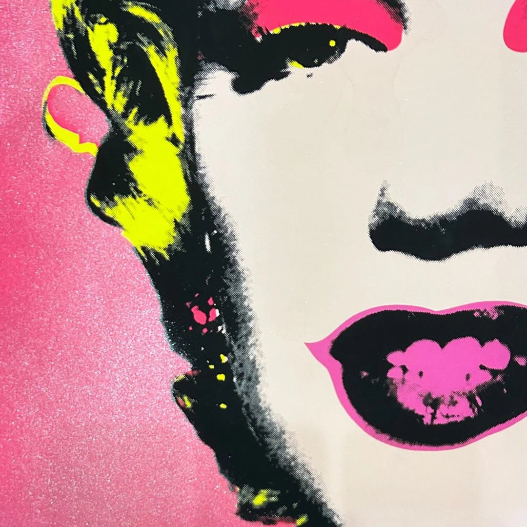artwork of a famous Andy Warhol pop art portrait Marilyn #31 with diamond dust background with bright colors on a pink background closeup