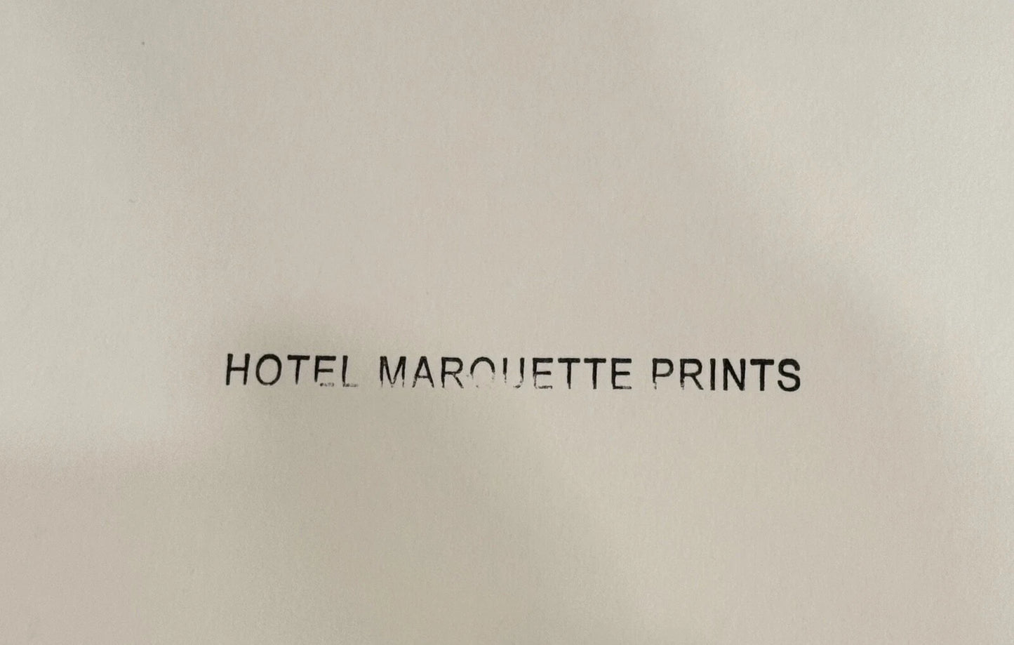 Text 'HOTEL MARQUETTE PRINTS' on a beige background