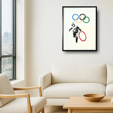 Framed artwork of a Banksy artwork. Olympic rings above a modern living room.