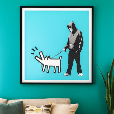 Framed Banksy artwork of a person walking a graffiti dog on a blue wall above a couch with patterned pillows.