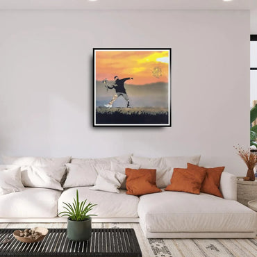 Framed artwork of a person against a sunset sky in a living room.