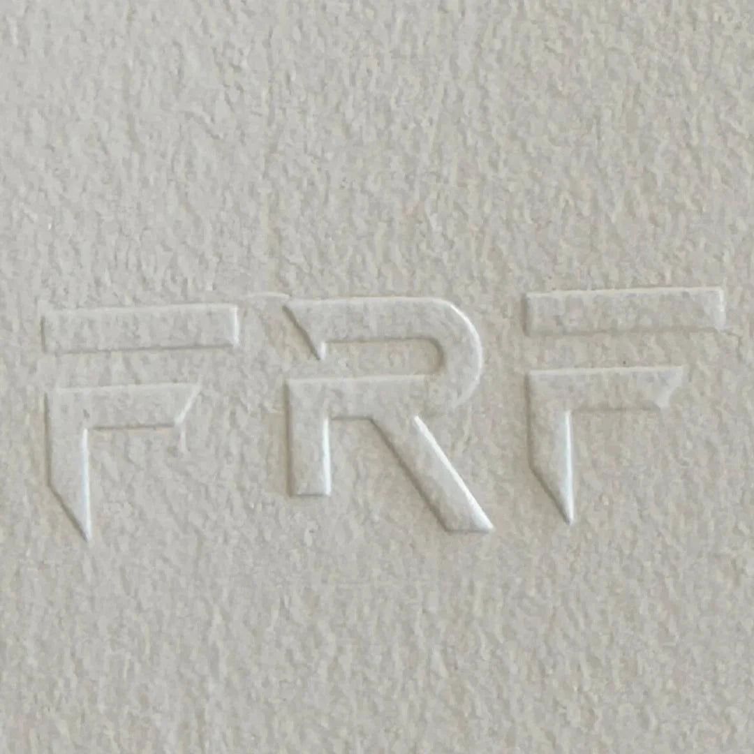 Textured white surface with embossed letters 'FRF' design