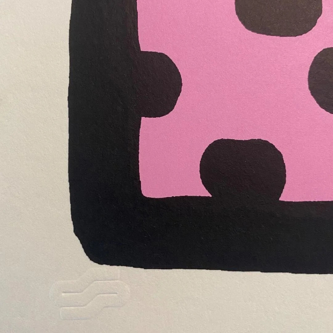 Close-up of a pink and black patterned product on a beige background