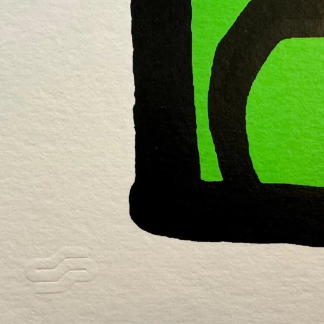 Close-up of a logo with green and black colors on a textured beige background