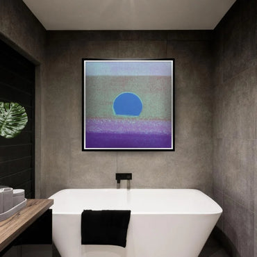 Modern bathroom with a white freestanding bathtub, black towel, and abstract art on the wall.