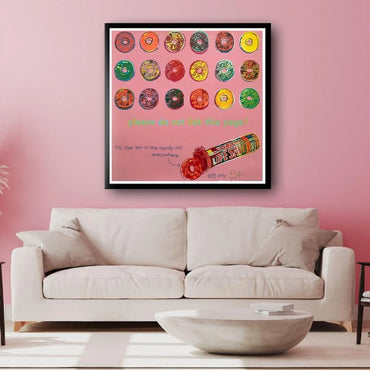 Framed artwork of Life Savers candy on a pink wall above a white sofa.