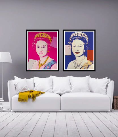 Two framed portraits on a wall above a white sofa with a yellow blanket.