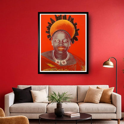 Framed artwork of a person with a headdress on a red wall above a beige sofa.