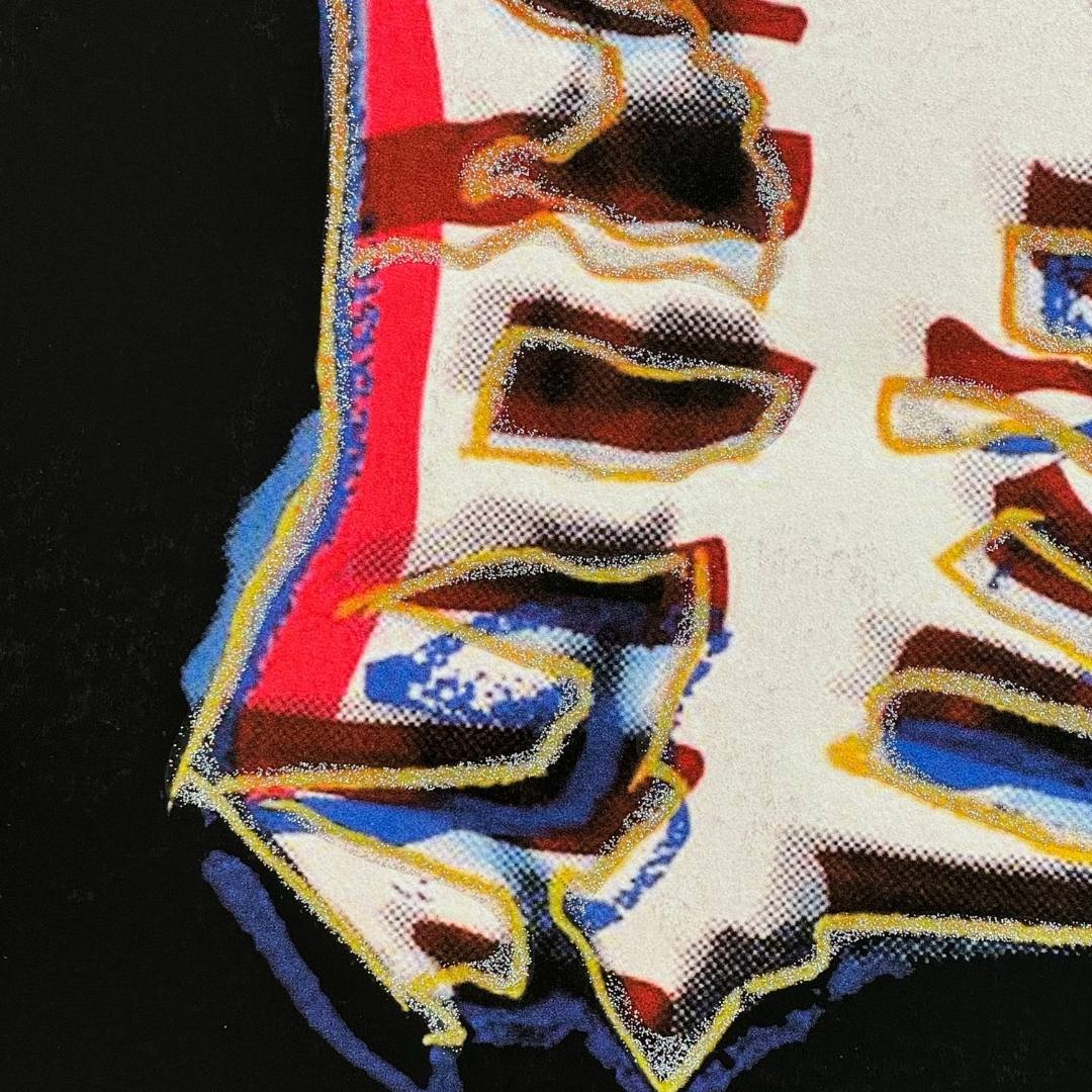Close-up of a colorful fabric with abstract patterns on a black background