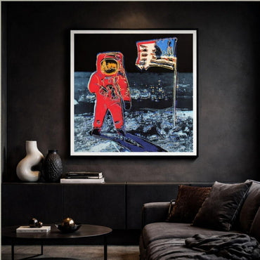 Framed artwork of an astronaut on the moon with a flag, displayed in a living room.