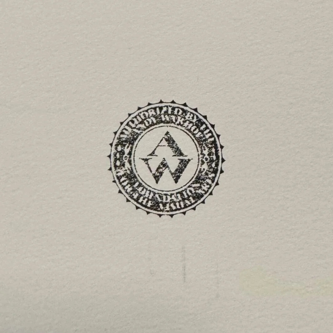 Colorful dollar sign artwork on a wall above a gray sofa in a living room.