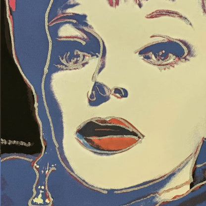 Close-up of a stylized face with bold makeup and geometric design elements.