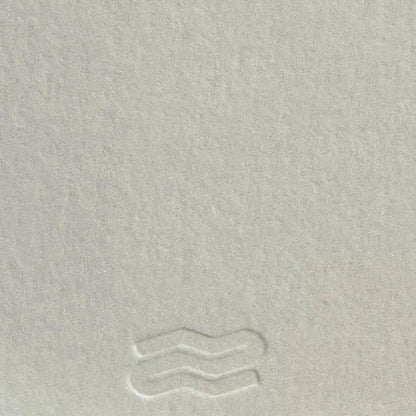 Close-up of a textured light gray surface with subtle patterns.