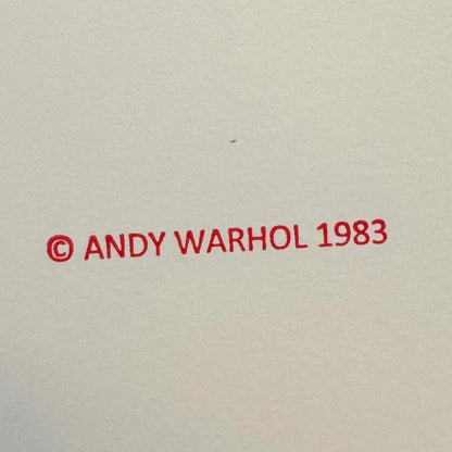 Red text '© ANDY WARHOL 1983' on a beige background