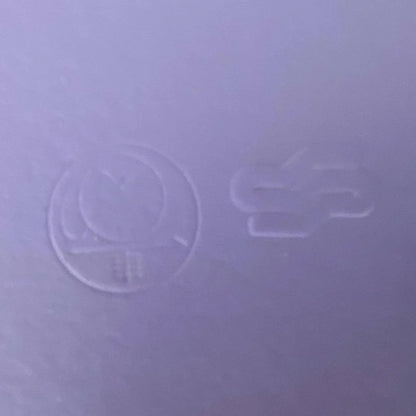 Close-up of a textured purple surface with embossed symbols.