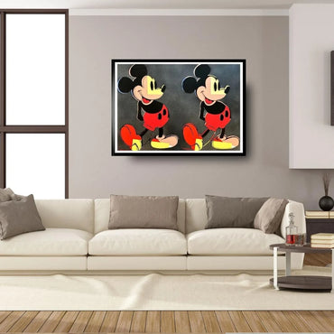Framed artwork of a cartoon character on a wall above a sofa in a living room.