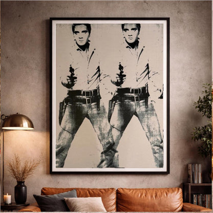 Framed artwork of a stylized portrait on a wall above a sofa.
