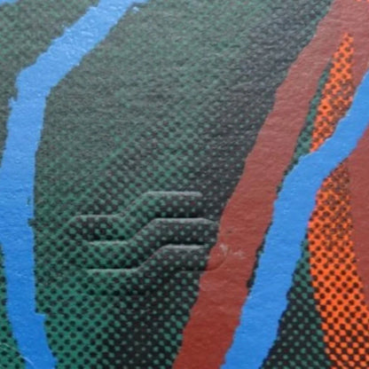 Close-up of textured fabric with blue, green, and orange patterns