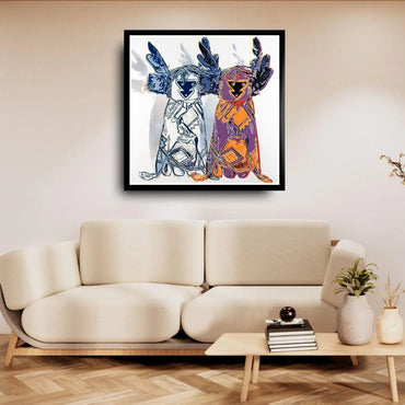 Framed abstract artwork on a wall above a beige sofa in a living room.