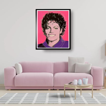 Framed portrait of Michael Jackson on a wall above a pink sofa in a living room.