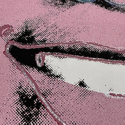 Close-up of a pink face with black and white patterns