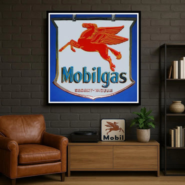 Vintage Mobilgas painting on a brick wall with a brown leather chair and wooden cabinet.