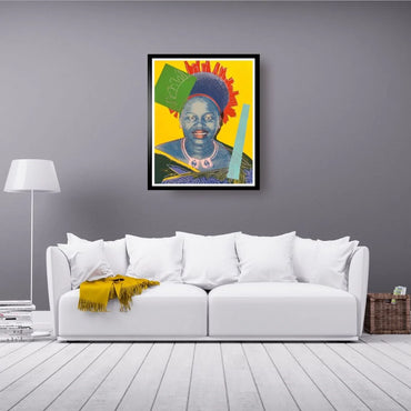 Colorful painting of a woman on a gray wall above a white sofa with a yellow blanket.