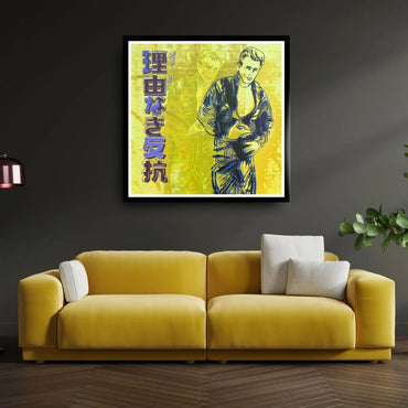 Yellow sofa with white cushions in a room with a framed artwork on the wall.