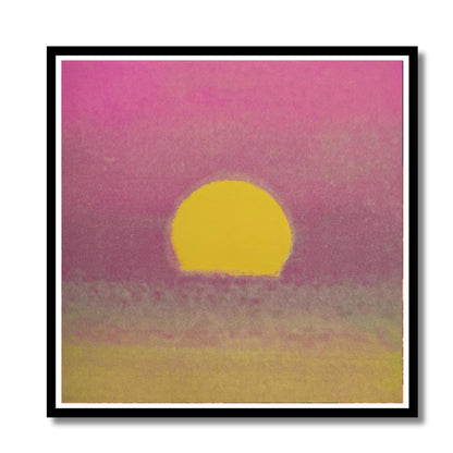 Framed artwork of a yellow sun setting over a pink and purple sky.