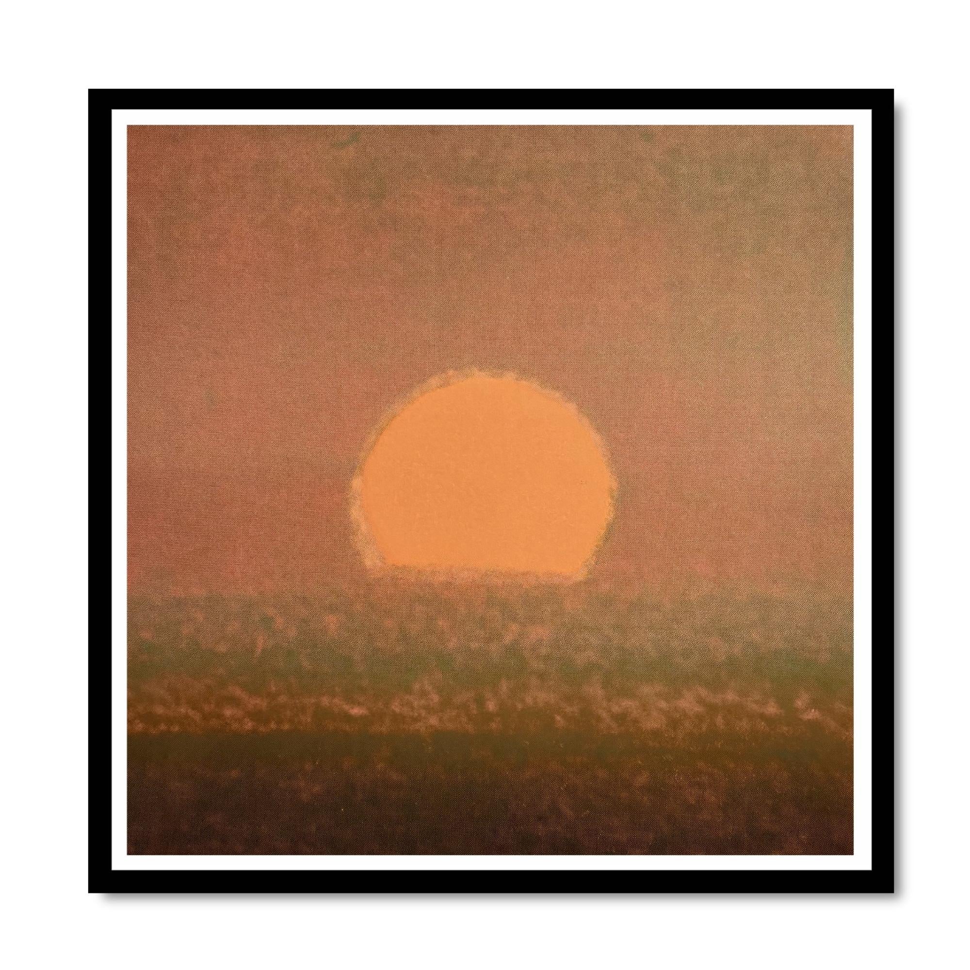 Framed artwork of a sunset with a large orange sun over a field.