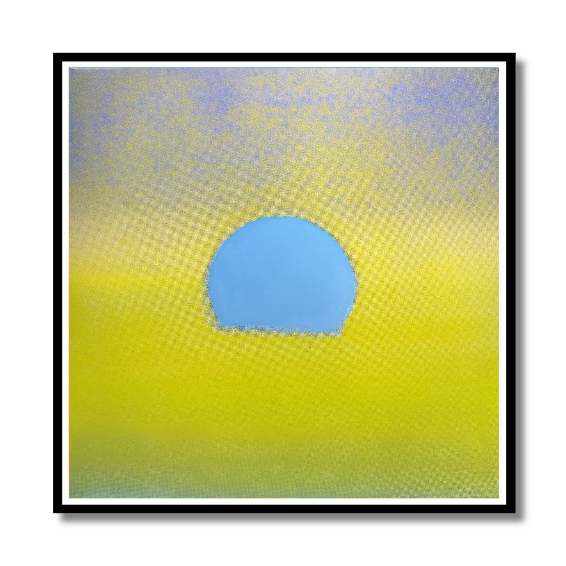 Abstract square wall art featuring a soft yellow field with a central light blue oval shape, presented in a black frame with a white mat against a white background.