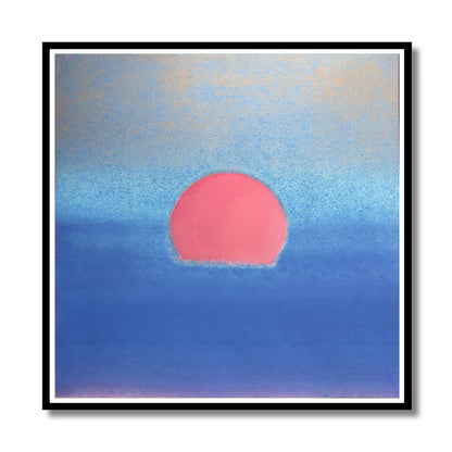 A square framed pastel artwork featuring a pink sun over a blue ocean, with a black frame and white mat on a white background.