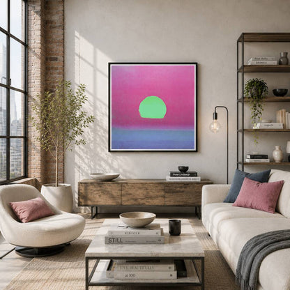 A framed abstract wall art print hangs above a wooden console in a modern living room. The artwork features a bright green oval on a pink-to-purple gradient background.