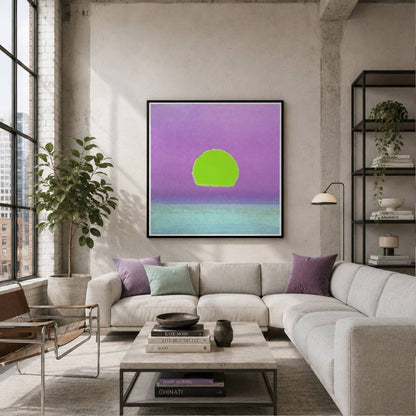 A framed abstract art print featuring a bright green circle against a purple and teal gradient background, displayed on a concrete wall above a modern light gray sectional sofa in a styled living room.