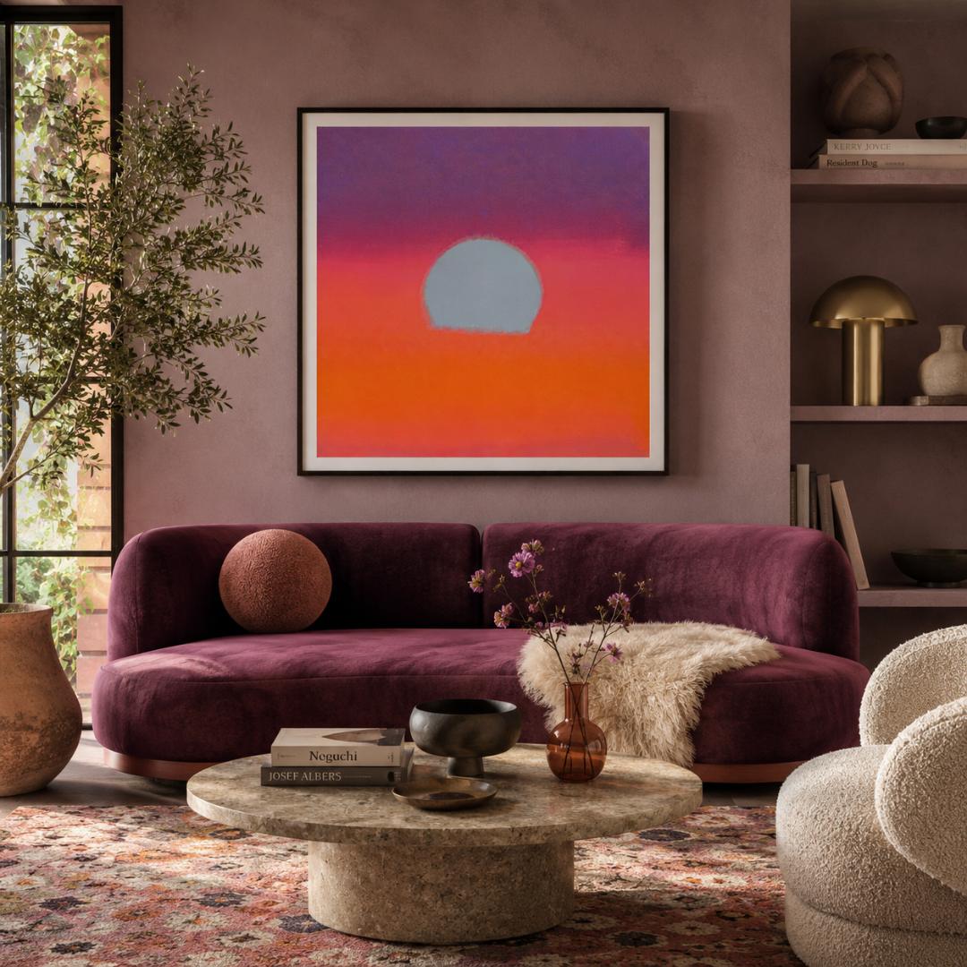 Living room with a purple sofa, round coffee table, and abstract sunset painting on the wall.