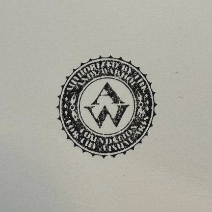 Circular logo with text and design elements on a light gray background